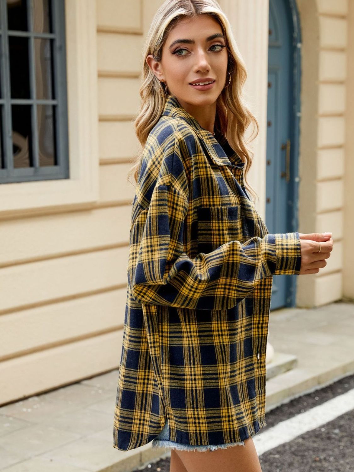 Checkered long sleeve collared top in navy and gold plaid with button front.
