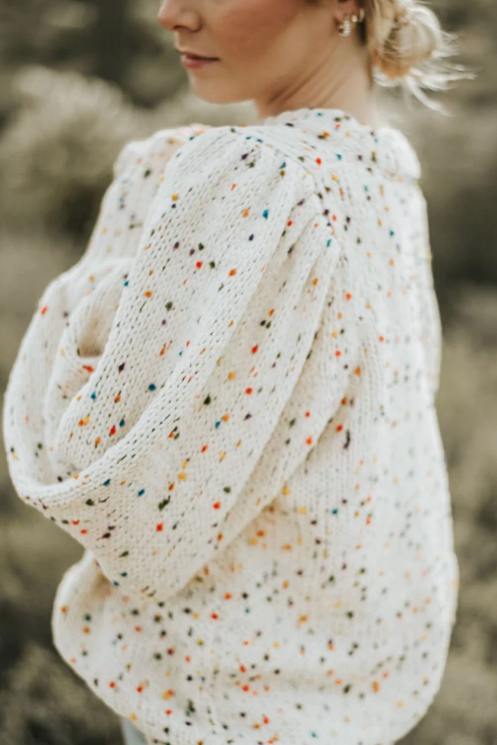 Cream speckled puff sleeve knit sweater with textured sleeves.