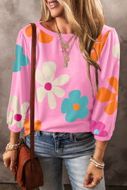 Pink long sleeve t-shirt with a retro floral print and puff sleeves.