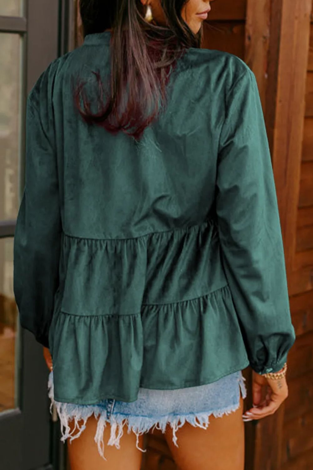 Dark green corduroy tiered button-up blouse with long sleeves and ruffled tiers.