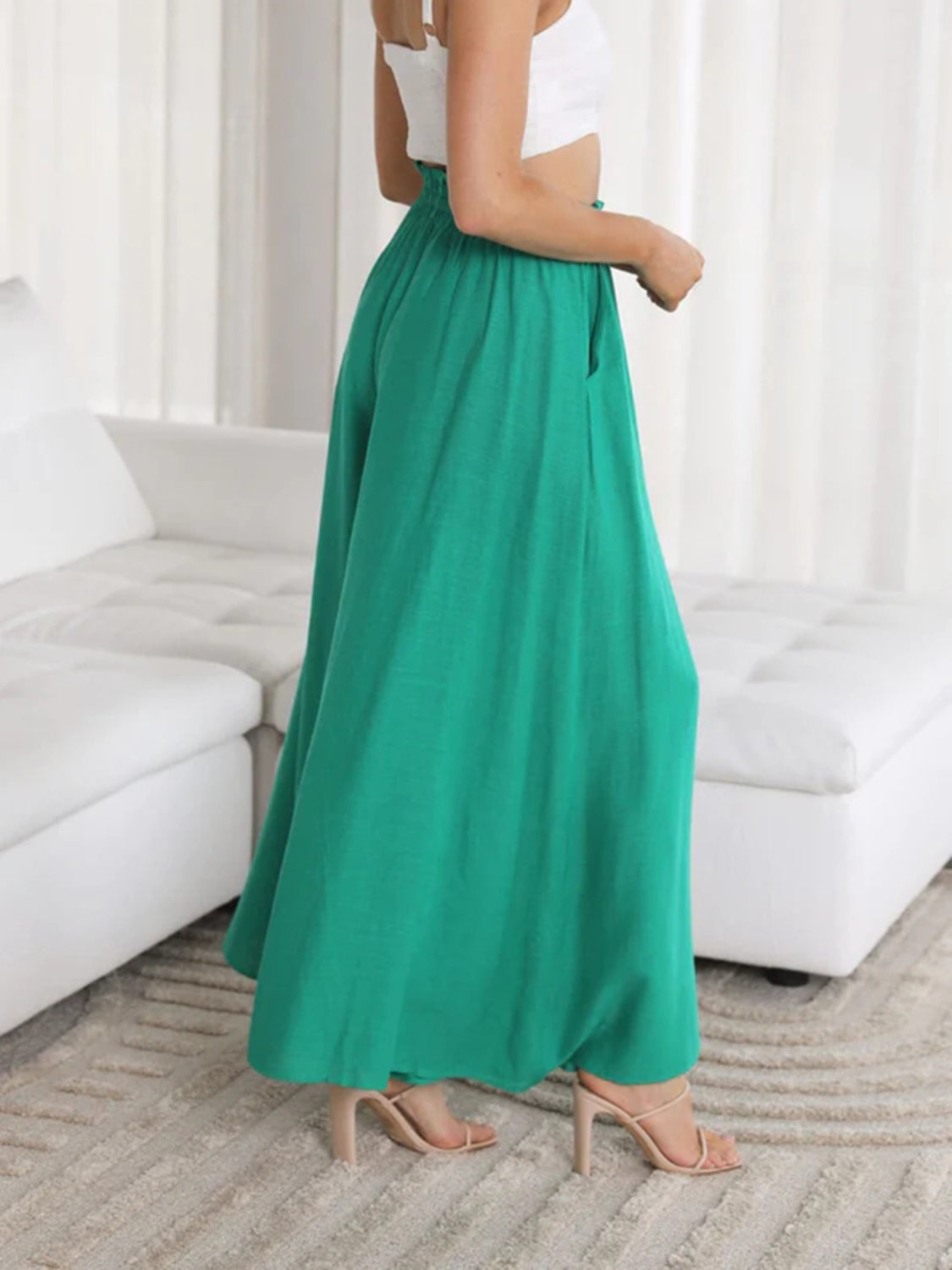 Textured drawstring palazzo trousers in turquoise with wide legs and pockets.