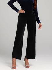 Black velvet palazzo trousers with a wide leg and high waist.