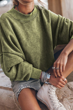 Moss acid wash mock neck sweatshirt with ribbed cuffs and neckline.