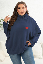 Navy turtleneck sweater with batwing sleeves and red heart appliqué detail.