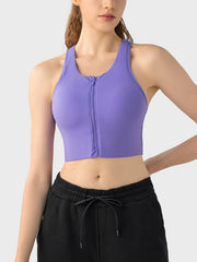 Purple zip-front racerback sports bra with a cropped fit.