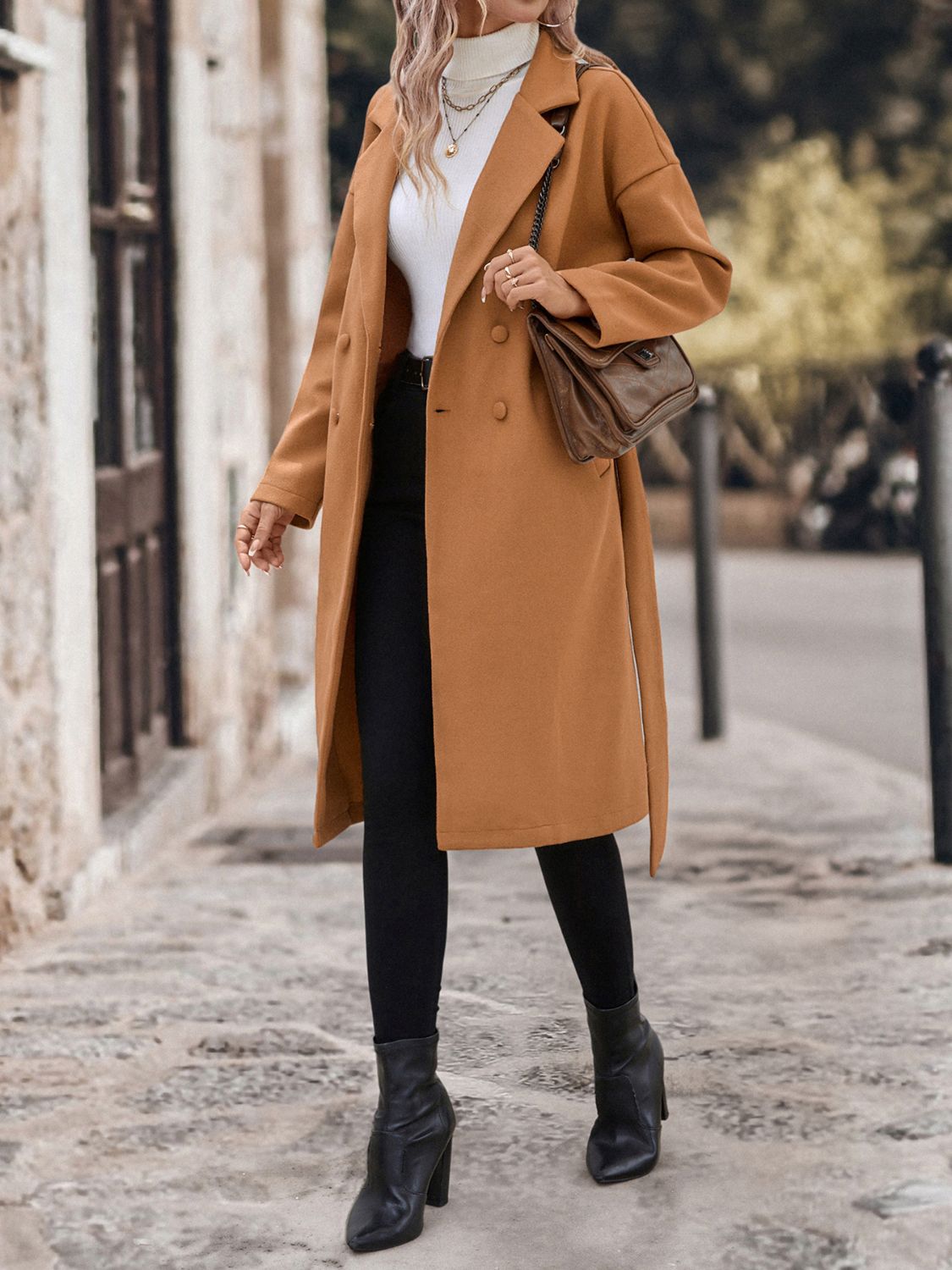 Caramel wool blend wrap coat with double-breasted closure and tie belt.