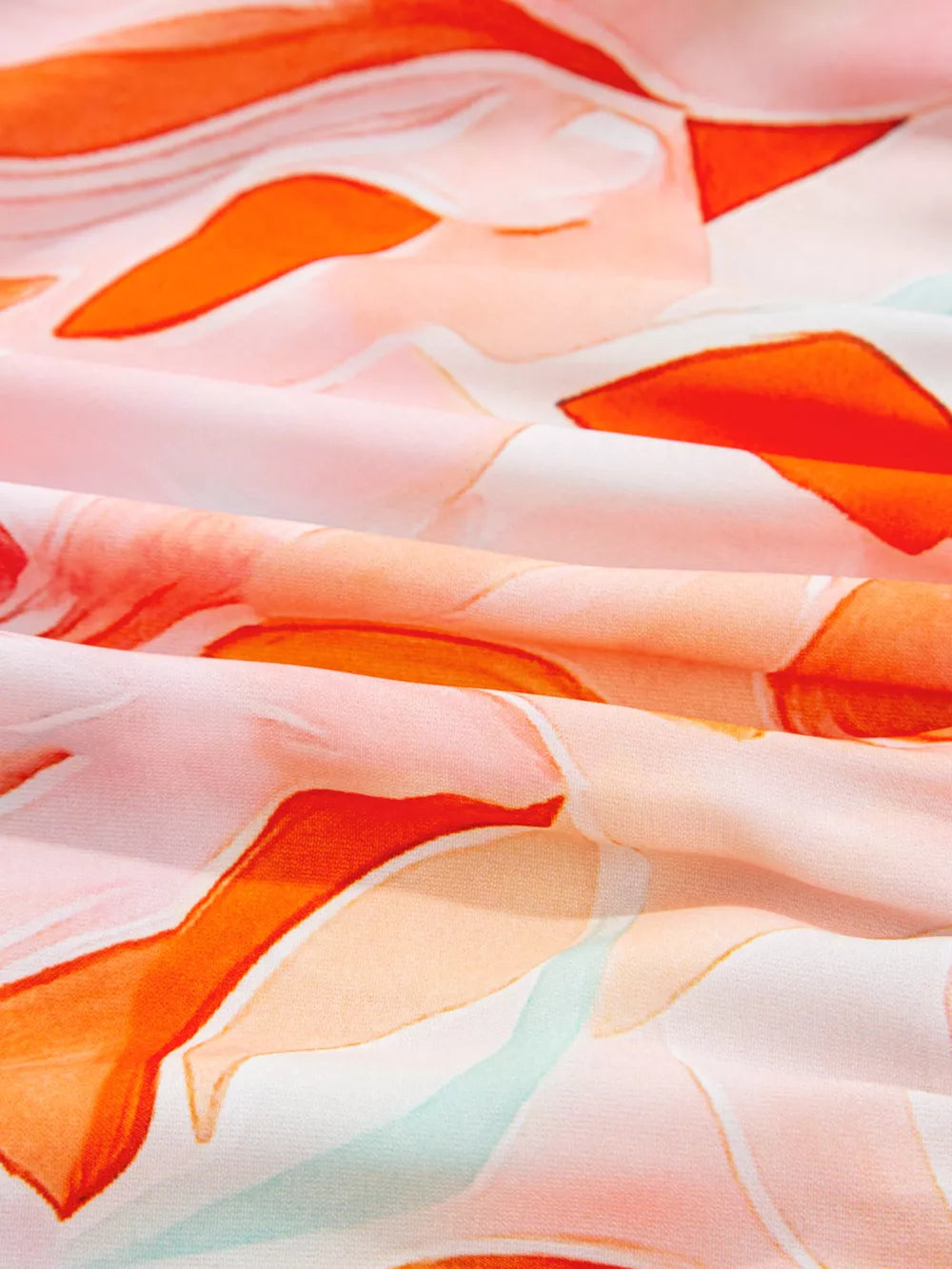 Vibrant abstract print mini dress with orange, pink, and white watercolor floral pattern.