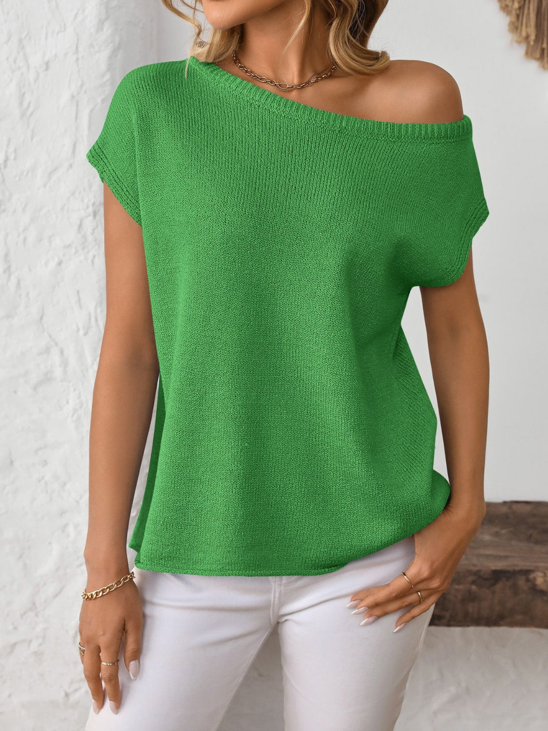 Green off-the-shoulder knit tee with short sleeves, boat neckline, and casual fit.