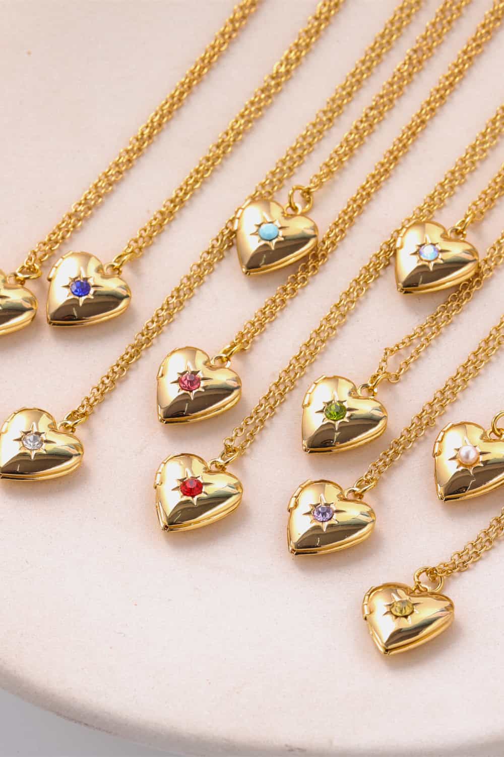 Gold heart locket necklaces with various gemstone colors and 14k gold chain.