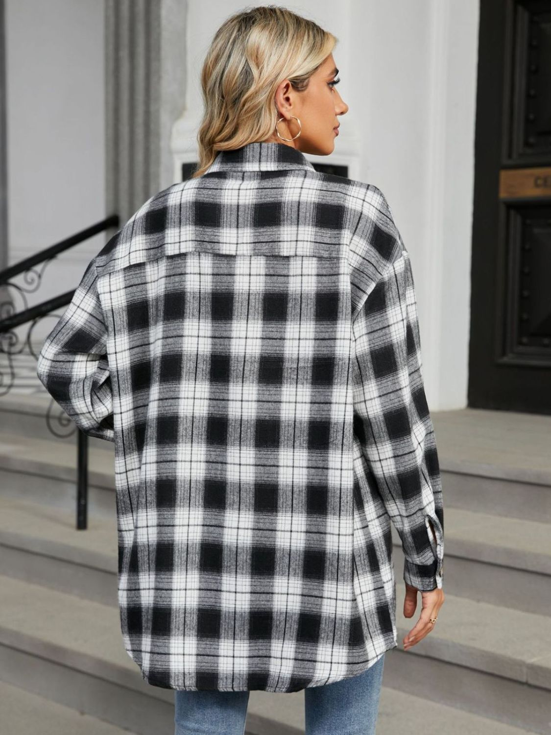 Oversized black and white plaid shacket with buttoned cuffs.