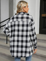 Oversized black and white plaid shacket with buttoned cuffs.