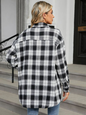 Oversized black and white plaid shacket with buttoned cuffs.