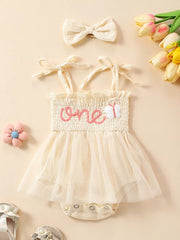Apricot smocked baby bodysuit with tulle skirt and matching headband.