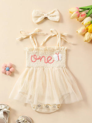 Apricot smocked baby bodysuit with tulle skirt and matching headband.