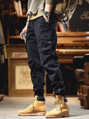 Men's black cargo joggers with drawstring and zippered ankle detail.