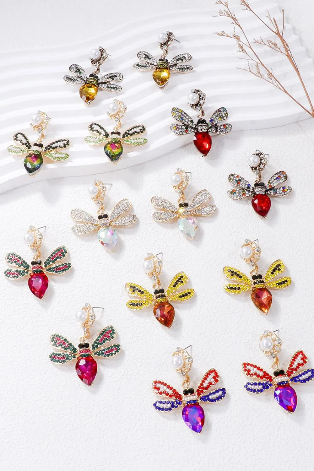 Jeweled dragonfly chandelier earrings in white, deep rose, gold, red, green, orange-red, red-violet.