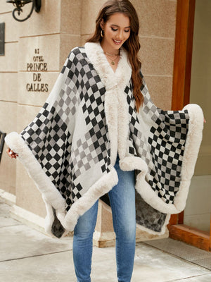 Diamond checkered poncho with faux fur trim in ivory and charcoal, open front style.