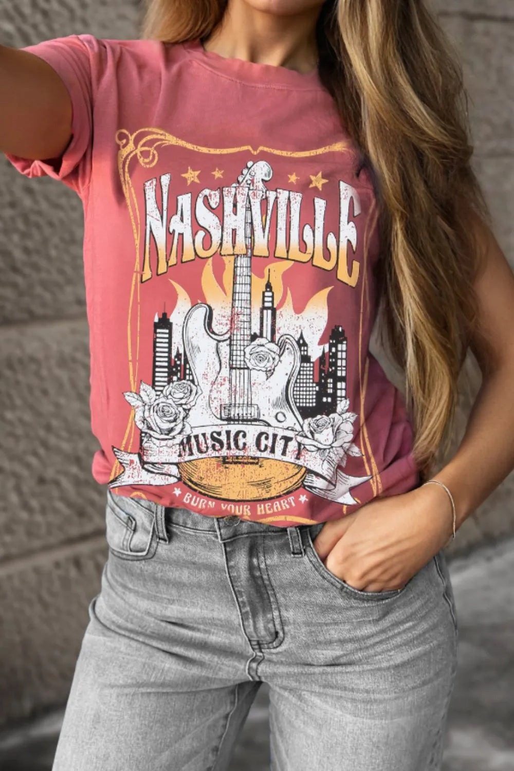 Burnt coral graphic tee with Nashville Music City guitar and city skyline design