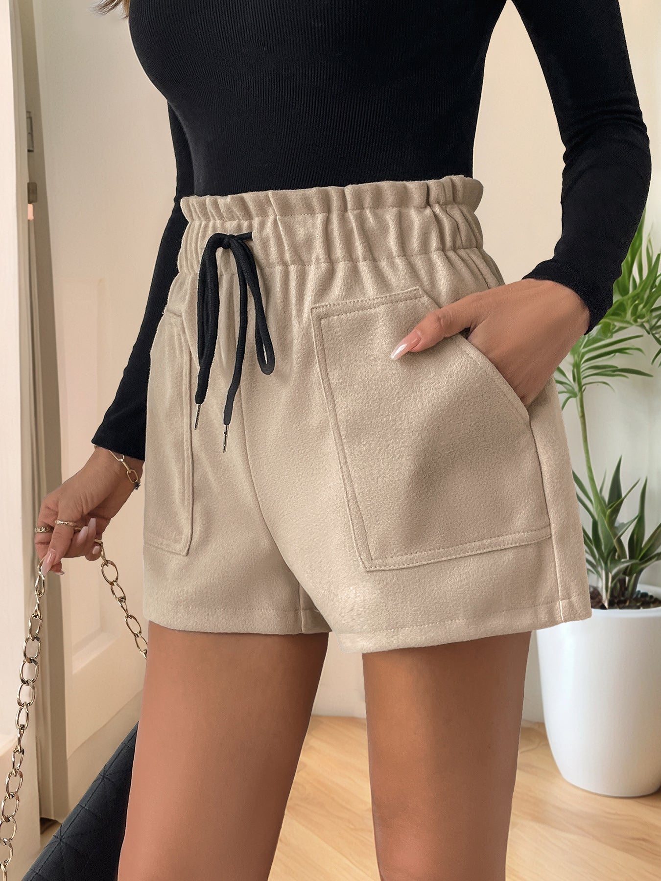 Tan paperbag waist utility shorts with drawstring and patch pockets.