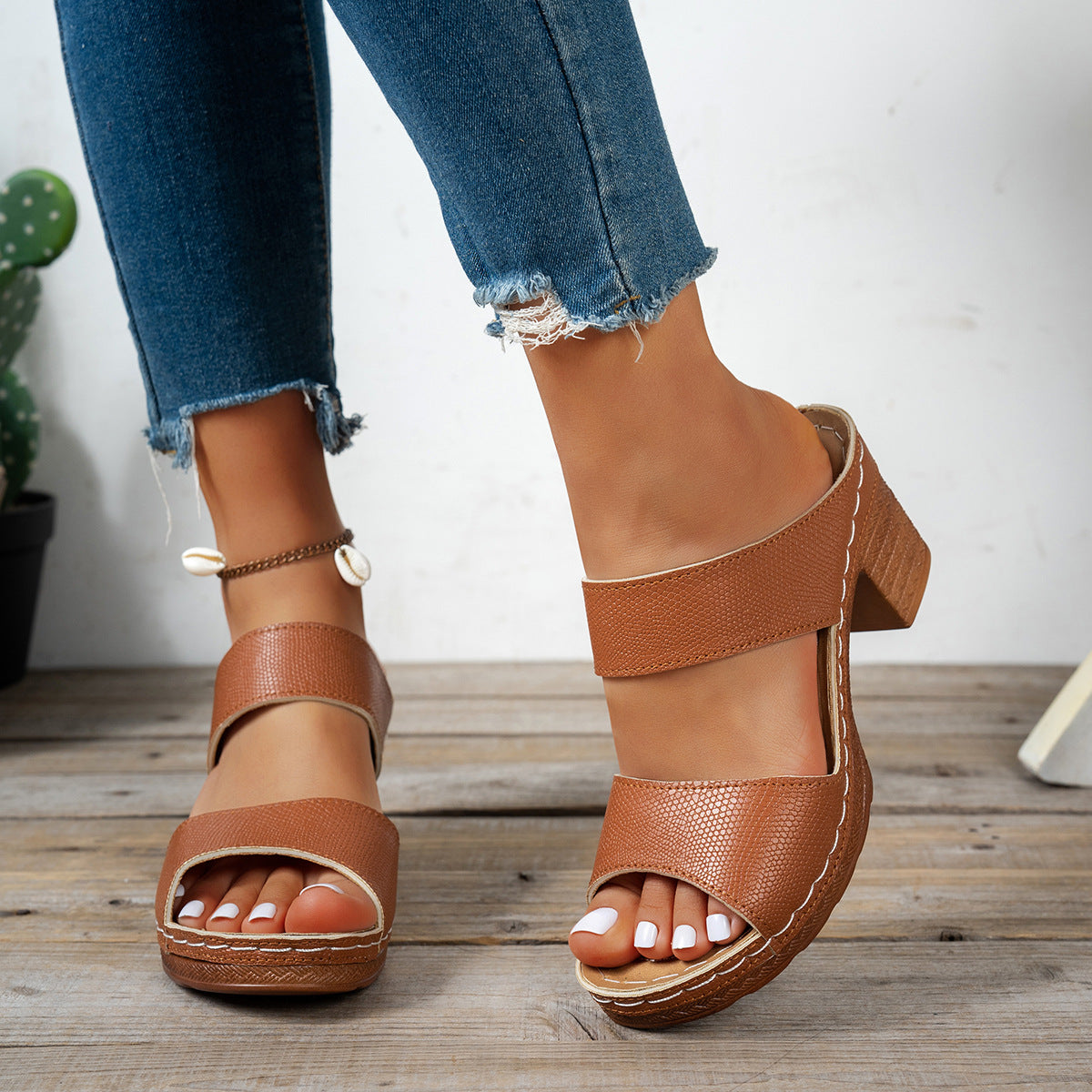 Brown textured strap block heel sandals with open toe and white stitching detail.
