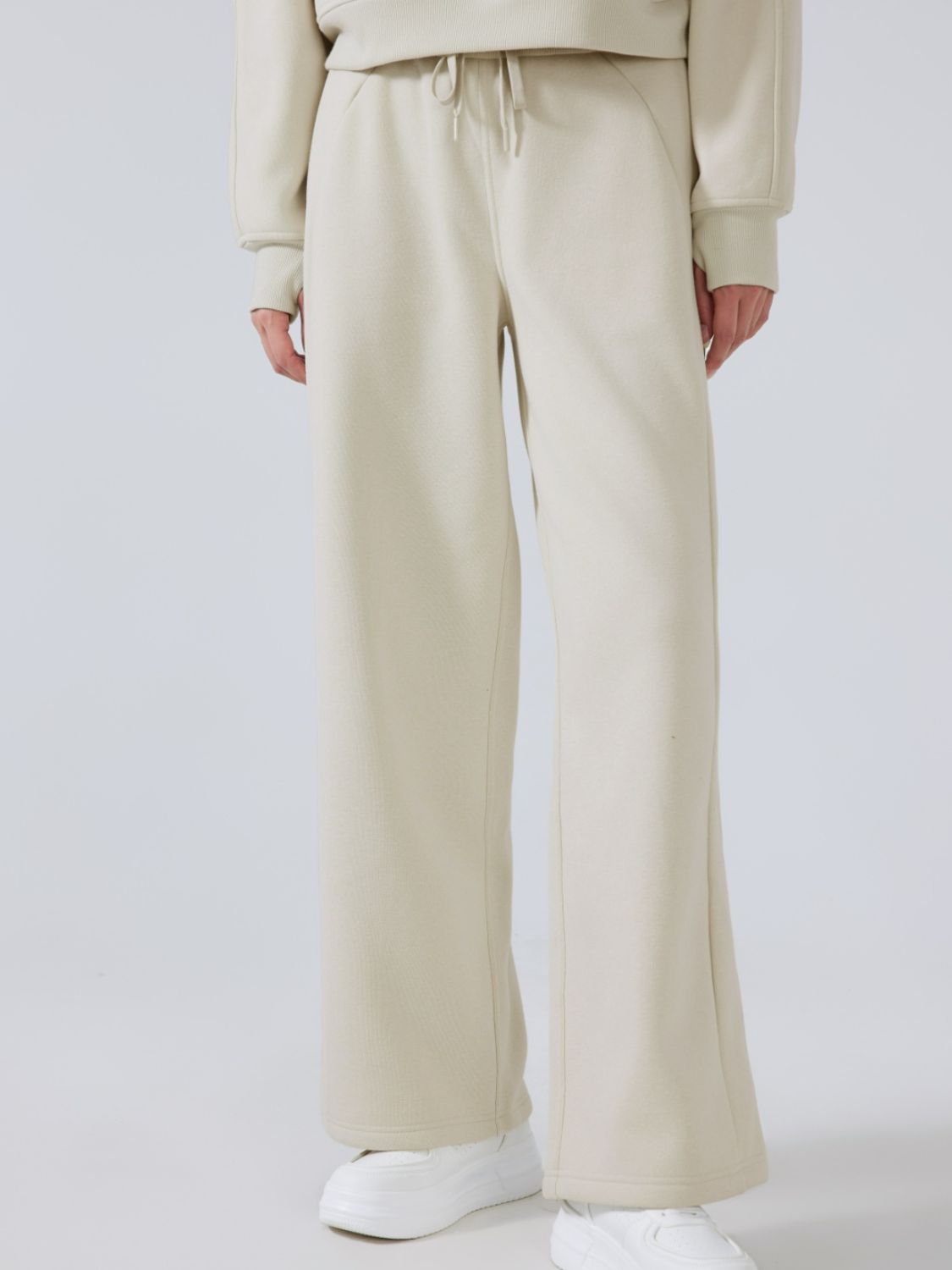 Relaxed palazzo sweatpants in beige with drawstring waist and wide leg