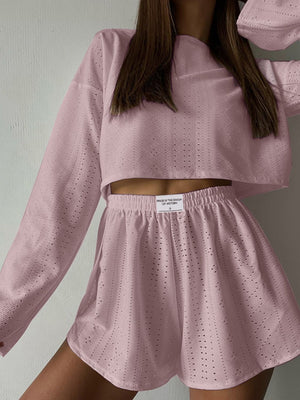 Blush pink perforated crop top and shorts set with a relaxed fit.