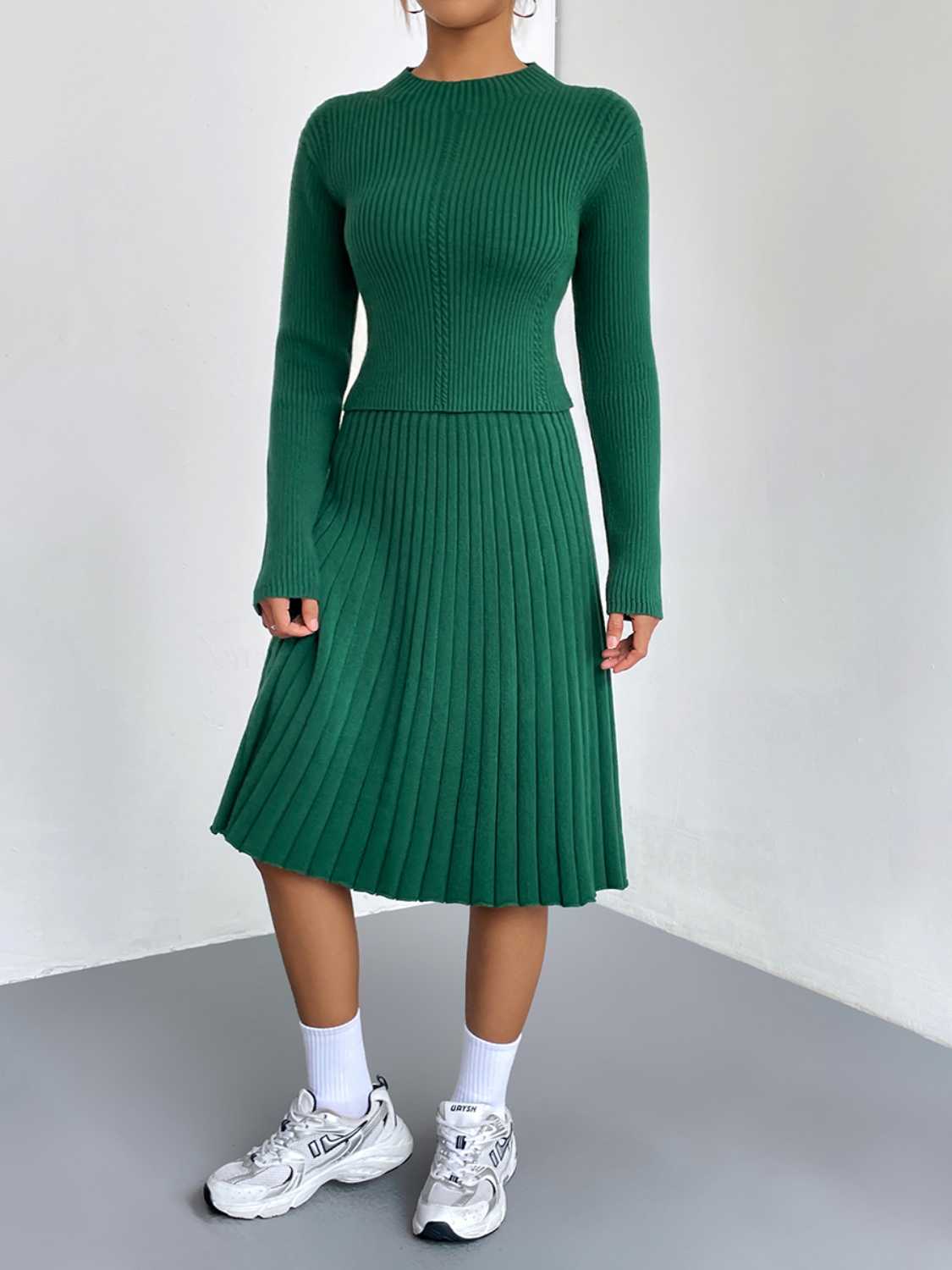 Green ribbed knit fit-and-flare co-ord set with long sleeves and a pleated skirt.