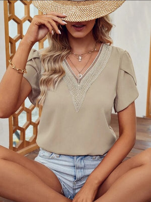 Khaki lace trim V-neck flutter sleeve blouse with layered necklaces.
