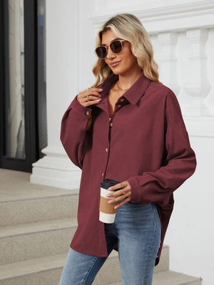 Burgundy corduroy oversized shirt jacket with button front and collar.