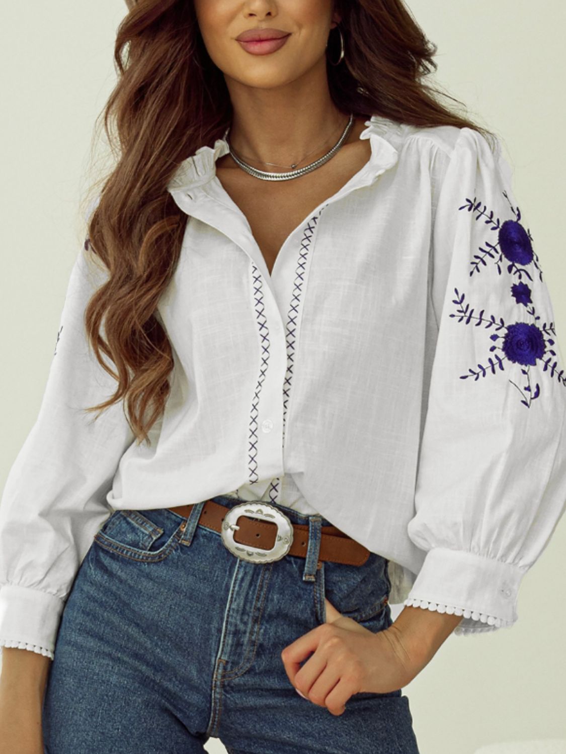 White embroidered linen blouse with scalloped trim and ruffled neckline