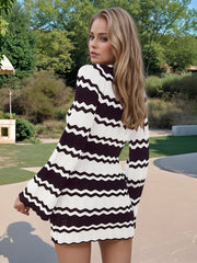 Chevron knit mini dress in black and white with long bell sleeves and a plunge neckline.