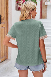 Sage eyelet blouse with lace trim on short sleeves and V-neck.