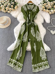 Green buttoned wide leg romper with white paisley print and collared neckline.