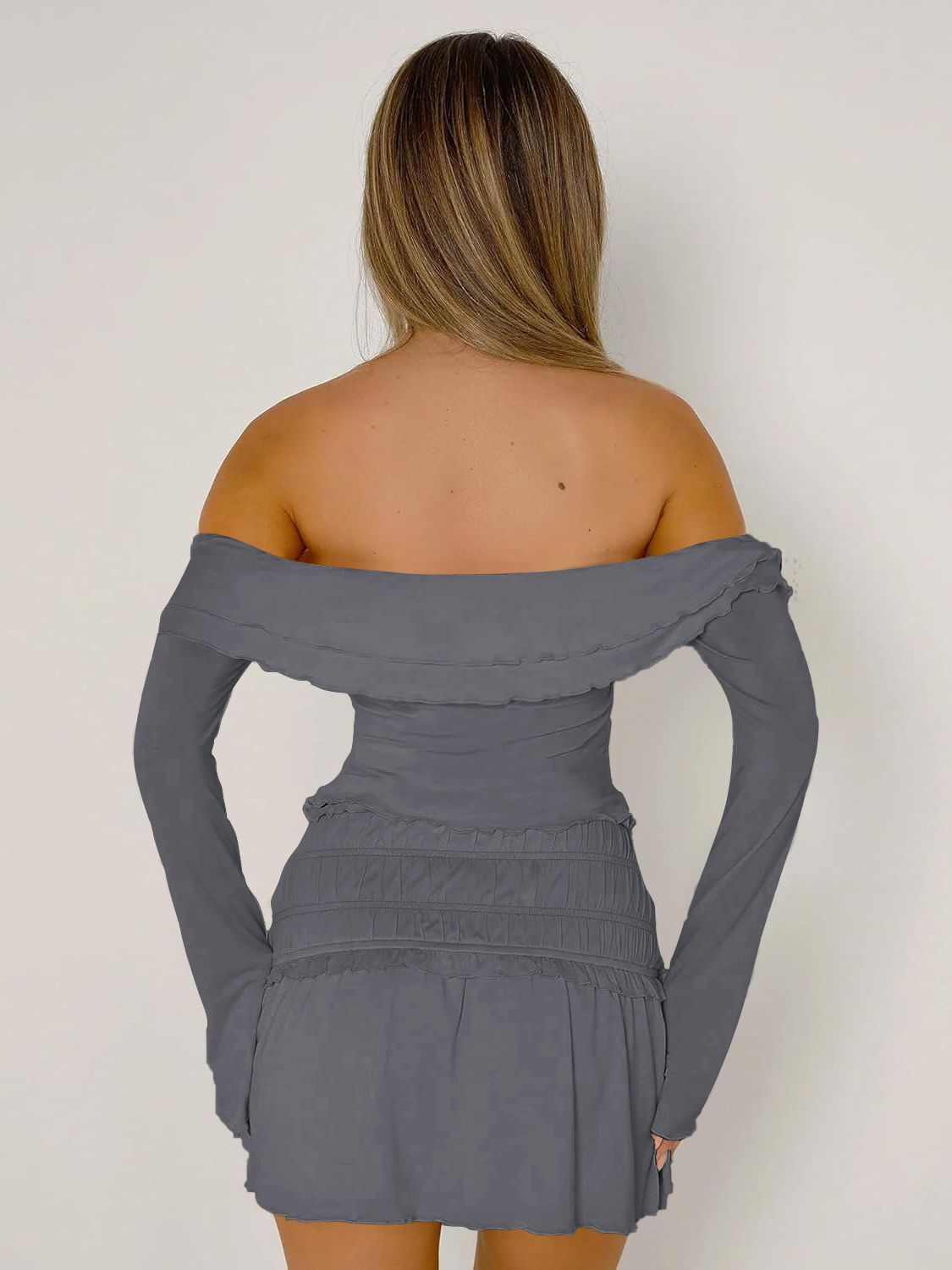 Dark gray ruched bodice off-shoulder top with long sleeves and ruffled neckline.