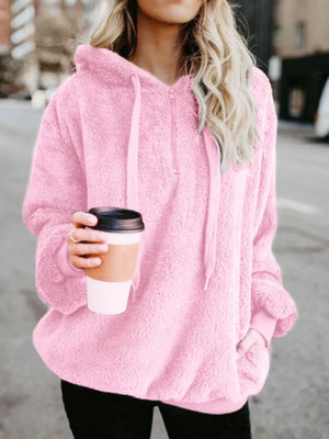 Pink fuzzy fleece half-zip hoodie with drawstring and kangaroo pocket.