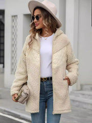 Cream teddy hoodie with quilted panels and zip front, styled with jeans.