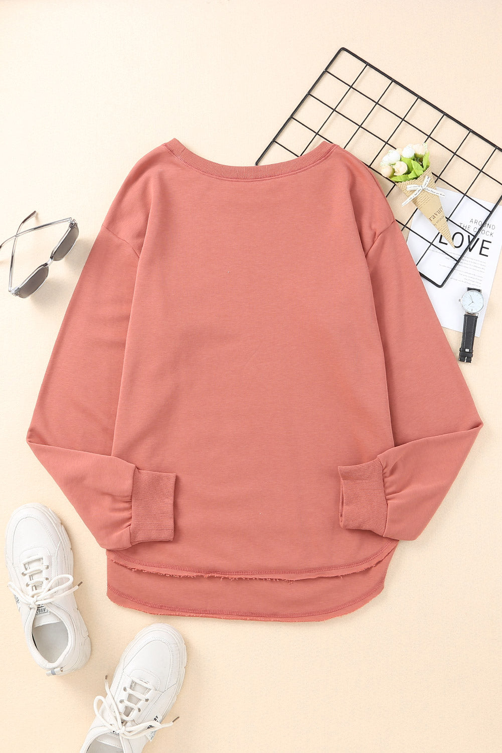 Rose pink sweatshirt with asymmetric hemline and raw edge detail