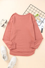 Rose pink sweatshirt with asymmetric hemline and raw edge detail