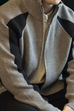 Gray ribbed zip-up track jacket with black contrast panels and a stand-up collar.