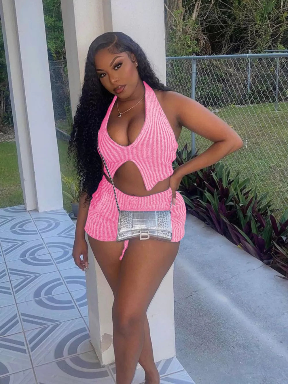 Pink knit halter top with cut-out detail and matching shorts.