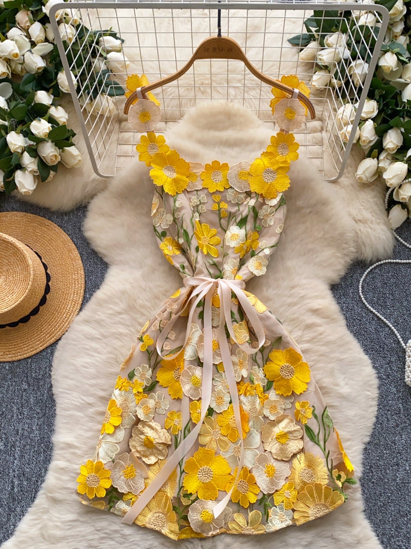 Embroidered floral mini dress in yellow and white with a bow detail.