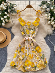 Embroidered floral mini dress in yellow and white with a bow detail.