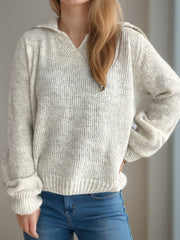 Textured knit polo sweater in beige with a V-neck and collar.