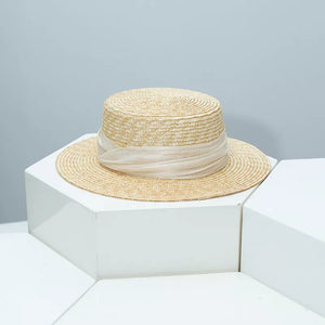 Elegant straw boater hat in tan with sheer ribbon trim