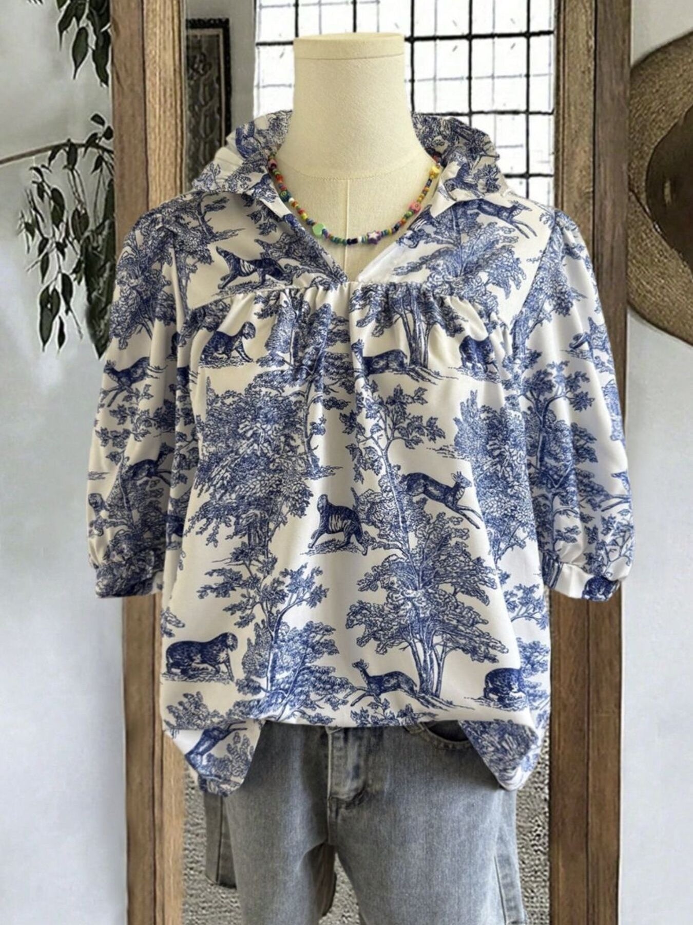 Toile de Jouy half sleeve blouse with a collared neckline and gathered details.