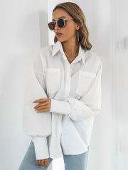 White poplin oversized blouse with blouson sleeves and two chest pockets.