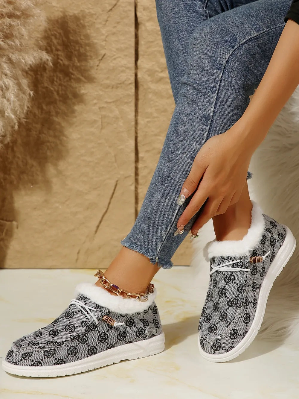 Southwestern print faux fur lined loafers in gray with white laces and wooden toggles.