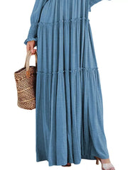 Blue smocked v-neck tiered maxi dress with ruffled details and long sleeves.
