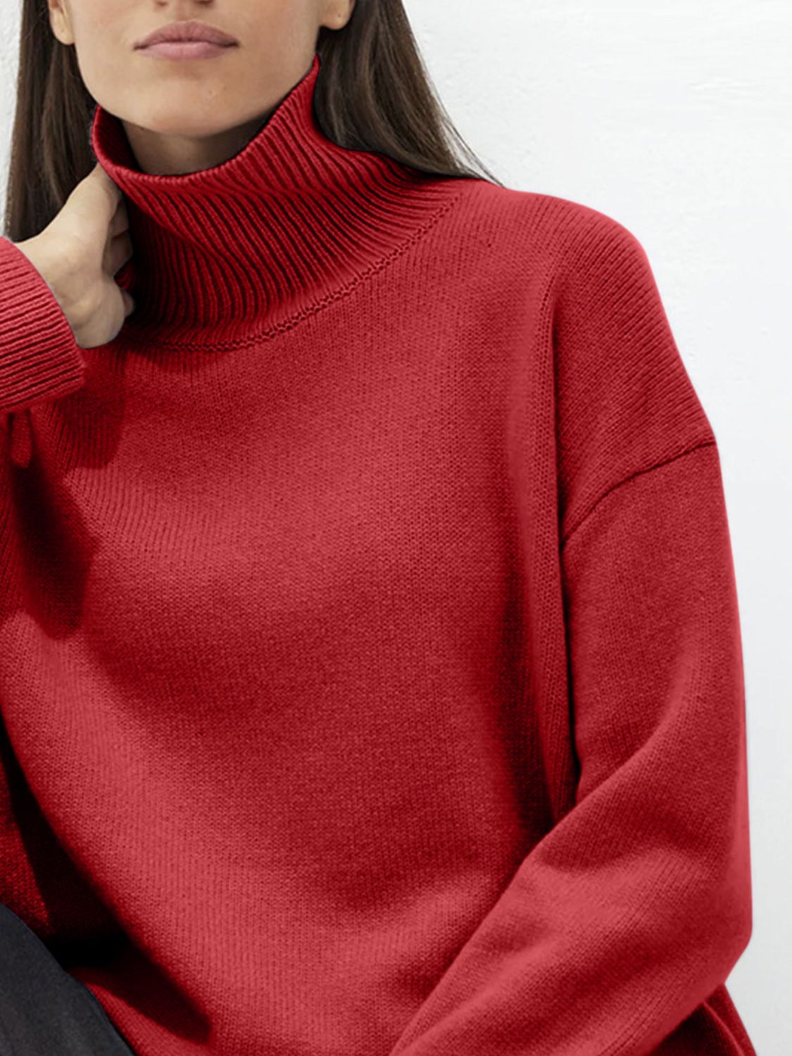 Relaxed turtleneck sweater in Deep Red acrylic with sculptural sleeves.