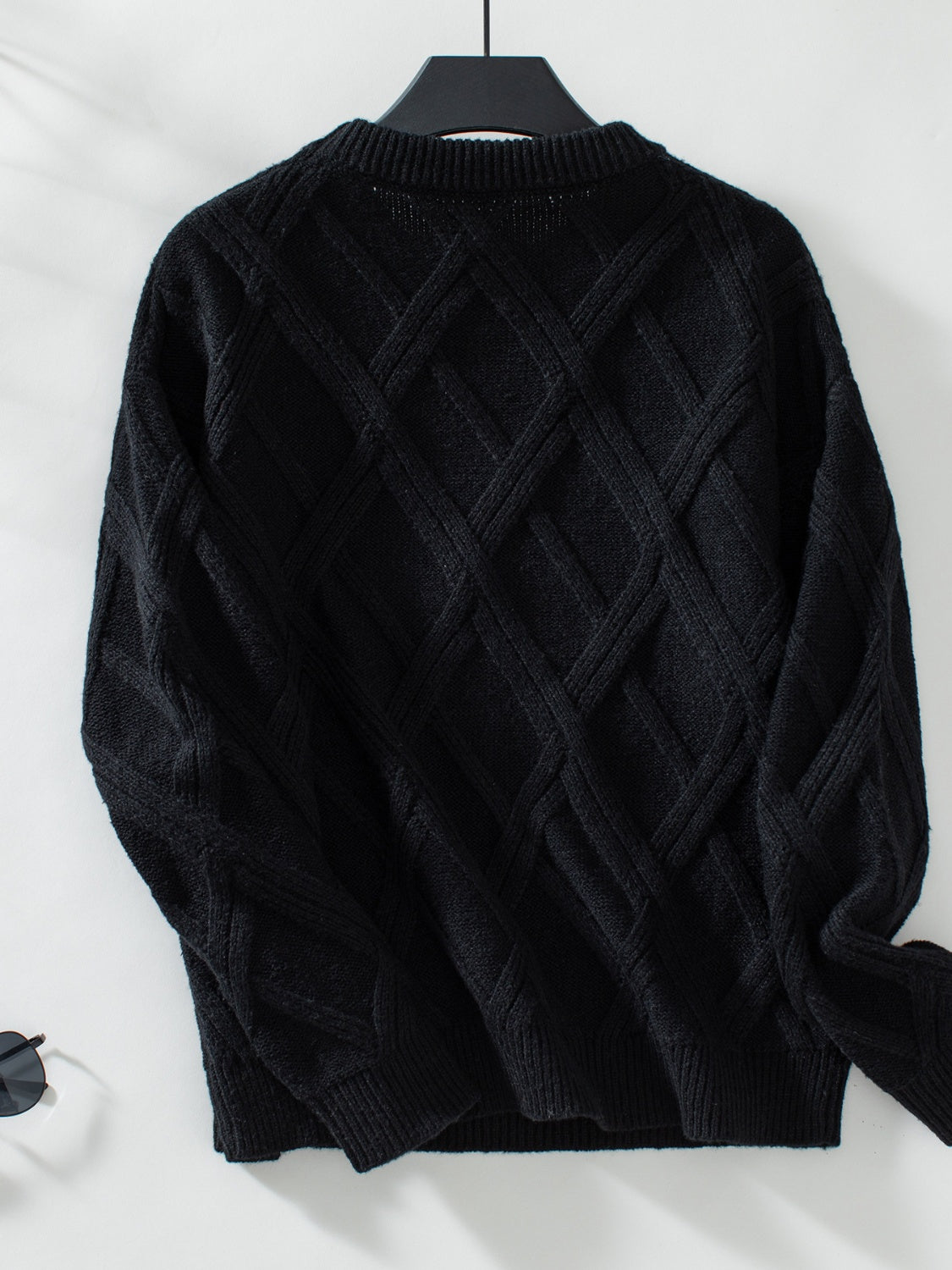 Black diamond cable knit crewneck sweater with ribbed cuffs and hem.